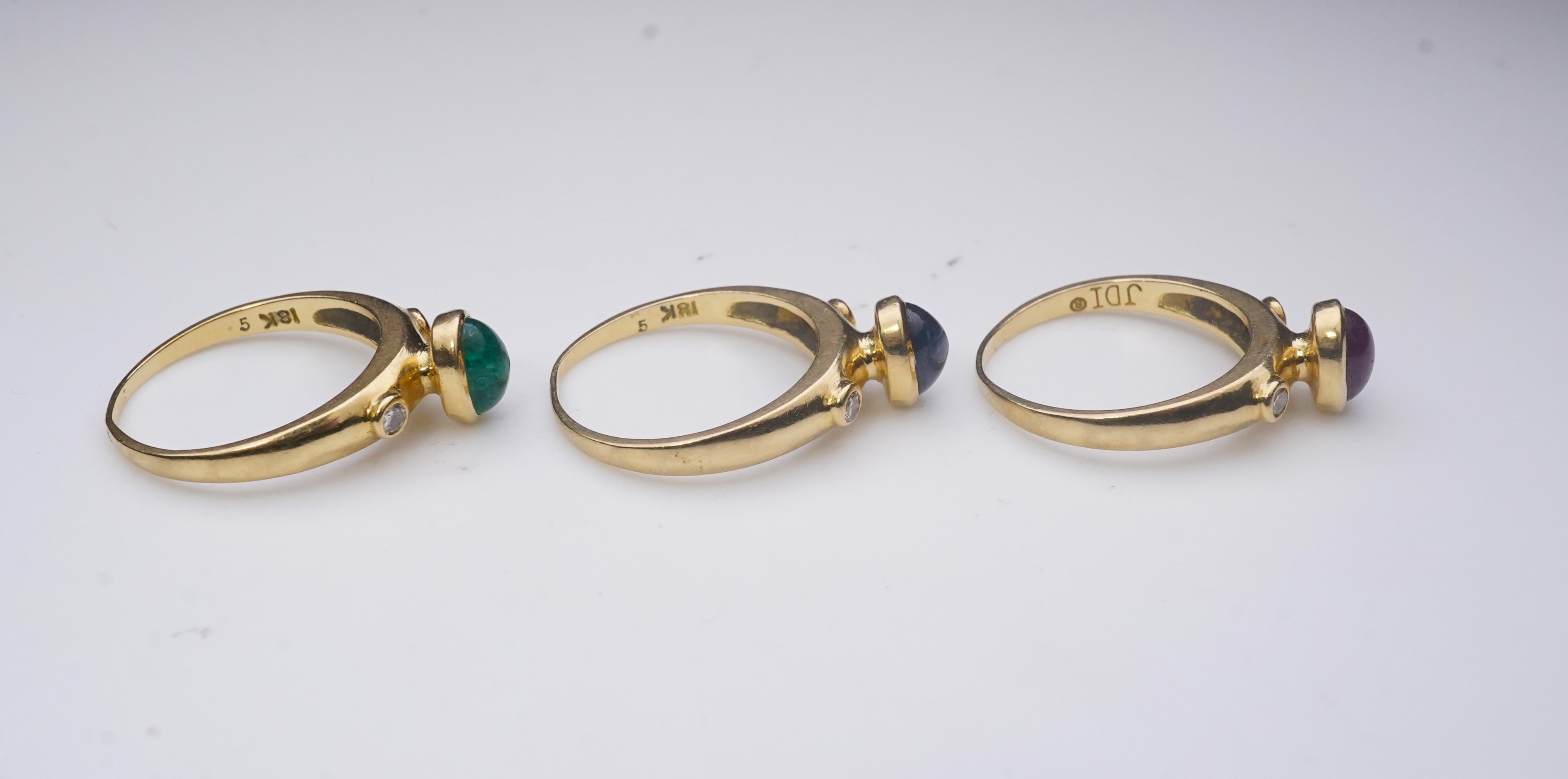 A suite of three gold and gem-set rings